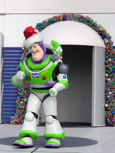 Jingle Buzz greeting guests in Tomorrowland in the Magic Kingdom
