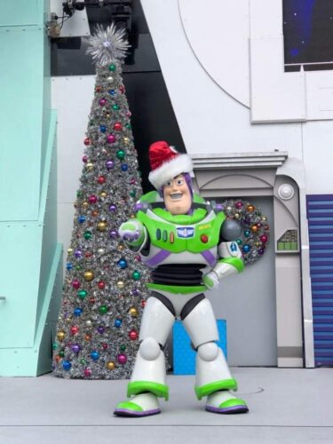 Jingle Buzz greeting guests in Tomorrowland in the Magic Kingdom