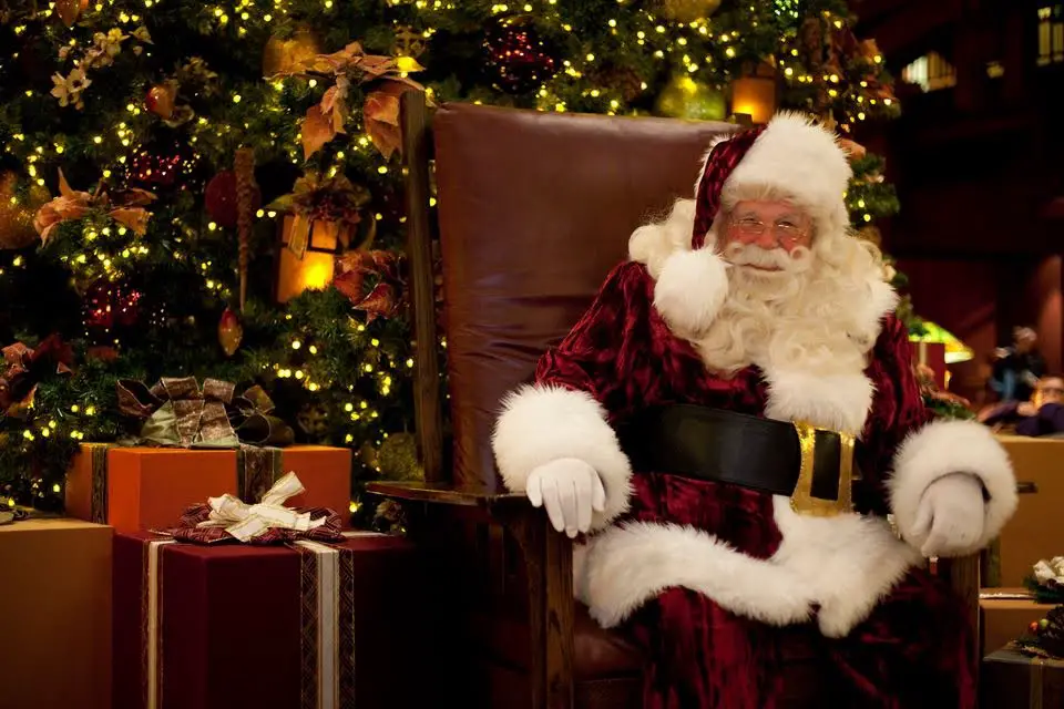 Cast Members meet a multiracial representation of Santa Claus at Disney World