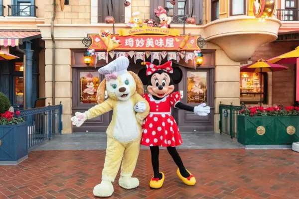 CookieAnn and Minnie Mouse pose in front of CookieAnn Bakery Café