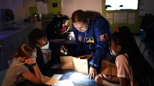 Teacher interacts with students using creative astronaut theme
