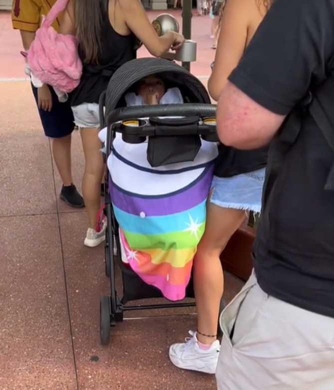 Viral video shows a family reportedly sneaking an older child into the Magic Kingdom