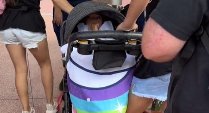 Viral video shows a family reportedly sneaking an older child into the Magic Kingdom