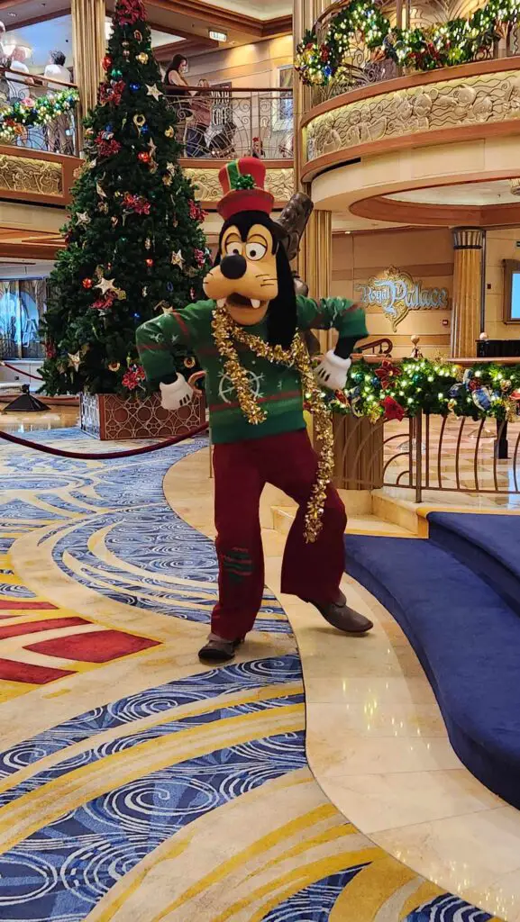 Mickey-Friends-Meeting-Guests-in-Holiday-Outfits-Onboard-Disney-Cruise-Line-Very-Merrytime-Voyages-goofy
