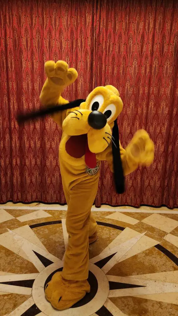 Mickey-Friends-Meeting-Guests-in-Holiday-Outfits-Onboard-Disney-Cruise-Line-Very-Merrytime-Voyages-pluto-1