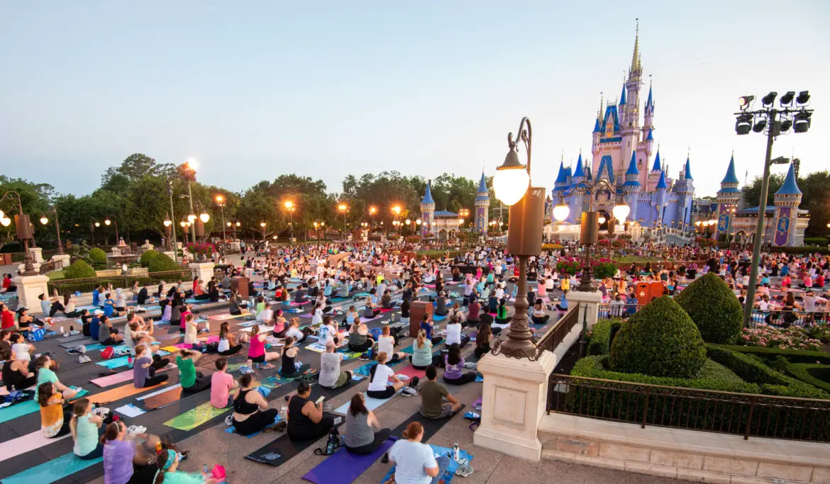 Disney World Cast Members Celebrate International Yoga Day in front of Cinderella Castle